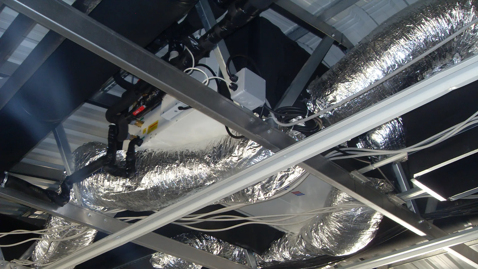 Flexible ducts and fan coils in a ceiling void