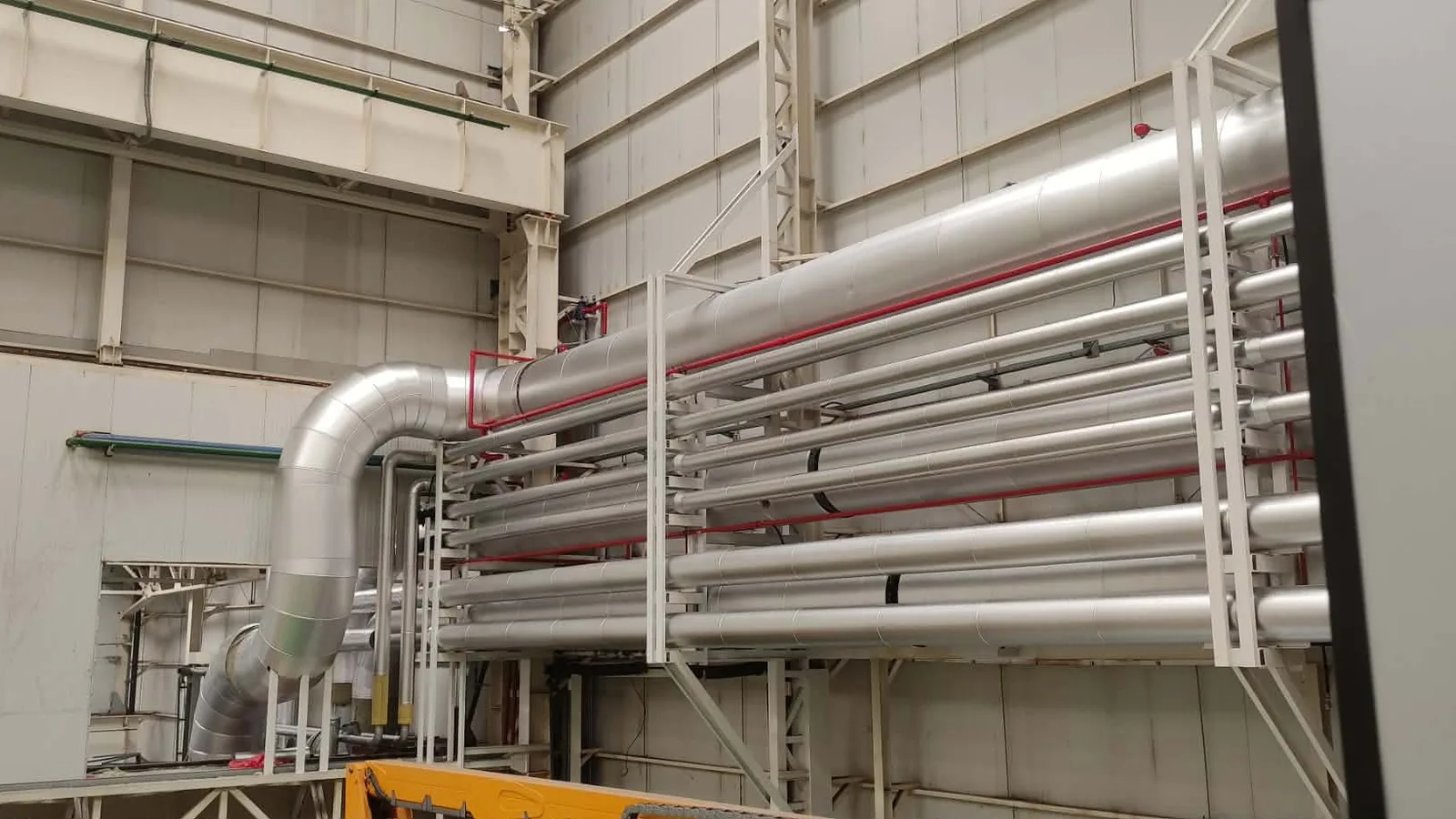 Insulated pipe runs inside a plant building